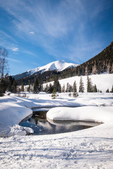Obraz na płótnie Canvas Snow covered frozen lake in holiday-resort Hohentauern on winter day