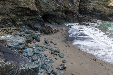 view from the top of the hill, the rocky coastline and the white water foam, the rocky mountains off the coast and the horizon