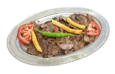 Traditional Turkish Doner Kebab on copper plate isolated on white