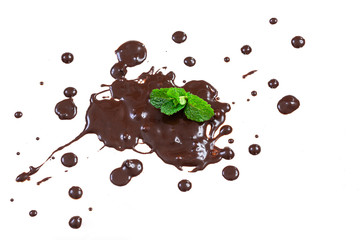 brownish chocolate splash isolated on a white with mint leaves