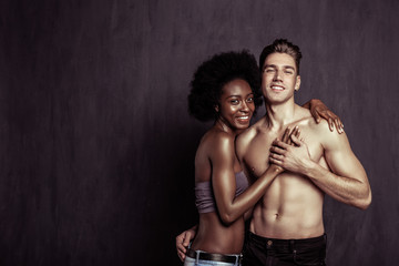 Pleasant happy man putting his girlfriends hand on his heart