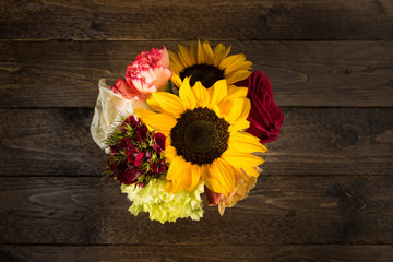 Bouquet of flowers on a wooden table background. Vintage floral background with spring flowers. Copy space