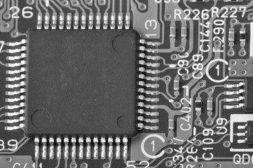 Fototapeta premium Electronic circuit board close up. Limited depth of field. Black and white image