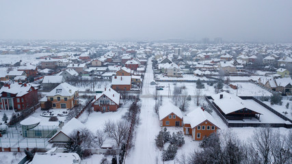 Village in the snow in winter with a bird's eye view