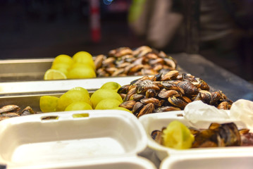 Mussels with lemons on a street food seller's stand in  the southern of Turkey, close up 