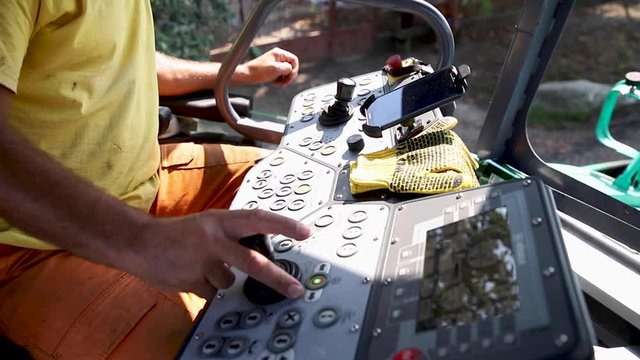 Tractor cabin control system. Hands of man. Driver