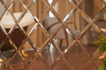 the pattern of mosaic square mirror tiles  in room