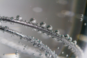 Air bubbles under the water on wire closeup