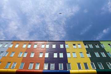 A colorful building like a rainbow in Amsterdam, Netherlands. This photo also includes blue and cloudy sky.