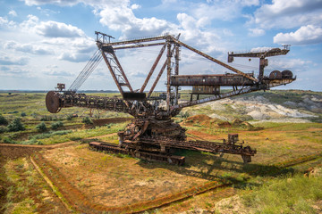 Fototapeta na wymiar Biggest excavator in the world working, Bagger 228, Ukraine. Big mine, develop mineral resources, excavator digs, metallurgy in Ukraine