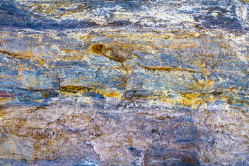 Colourful stone background texture, abstract formation of mineral rock in marine environment