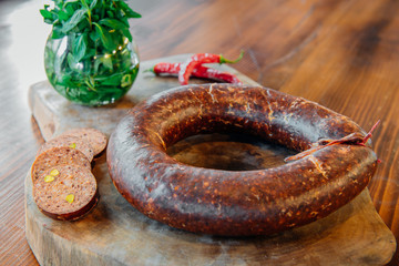 Traditional Turkish sausage meat sucuk on wooden table