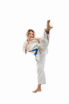 Female wearing martial arts uniform making karate move
