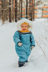 A child for a walk in the winter. Family walks in nature in winter. Family walk. Winter forest. Snow park.