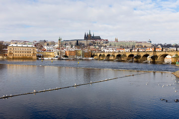 Fototapeta premium Snowy Prague Lesser Town with Prague Castle and Charles Bridge, Czech republic