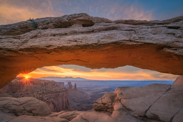 Mesa Arch sunrise and colorful clouds