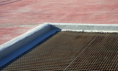 floor with brick tiles and ventilation grille