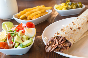 Turkish Doner Kebab, Shawarma or Gyros. Traditional Turkish Doner Kebab meat sandwich, shawarma or gyros in restaurant	