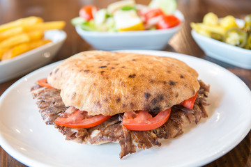 Turkish Doner Kebab, Shawarma or Gyros. Traditional Turkish Doner Kebab meat sandwich, shawarma or gyros in restaurant	