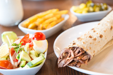 Turkish Doner Kebab, Shawarma or Gyros. Traditional Turkish Doner Kebab meat sandwich, shawarma or gyros in restaurant	
