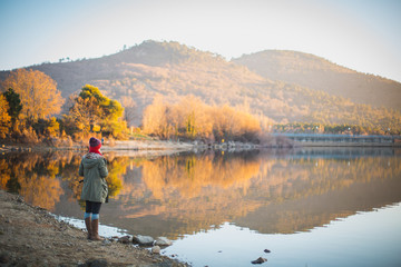 Fototapeta na wymiar young woman looking lake landscape