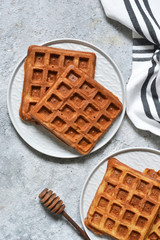 Belgian waffles on a kitchen concrete table. View from above.