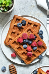 Belgian waffles on a kitchen concrete table. View from above.