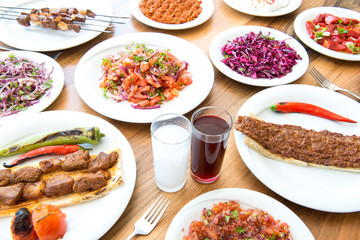 Traditional Turkish Adana Kebab or kebap meat food, raki and salgam in Turkish Restaurant with salad