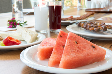 Traditional Turkish Adana Kebab or kebap meat food, raki and salgam in Turkish Restaurant with salad