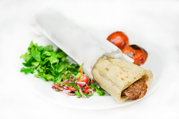 Traditional Turkish Adana Kebab durum wrap or kebap meat food in Turkish Restaurant with salad