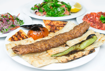 Traditional Turkish Adana Kebab or kebap meat food in Turkish Restaurant with salad