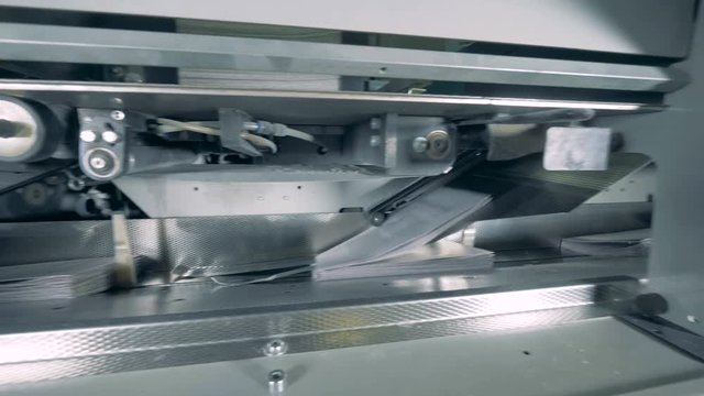Printing office machines working with paper, close up.