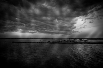 Fototapeta premium Black and white view of Punta Sabbioni and Sant Erasmo island in the Venice lagoon during a thunderstorm