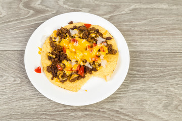 Spicy Beef Tostados on Corn Tortilla with Cheese and Salsa