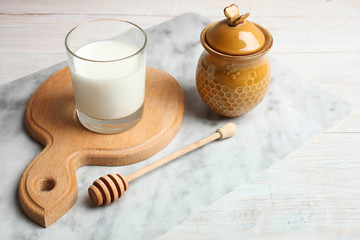 Glass of milk and jar of honey