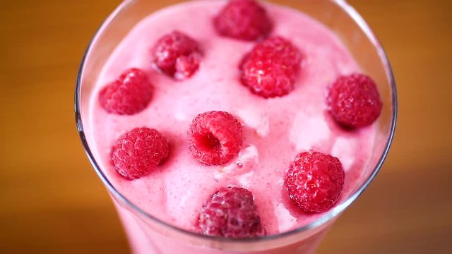 sweet organic smoothie with raspberry on wooden