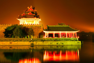 Night lighting corner towers of the Forbidden City. Beijing, China.