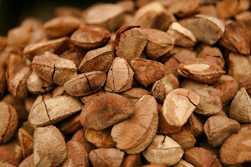 Unpeeled Brazilian nut lie on the counter close-up.