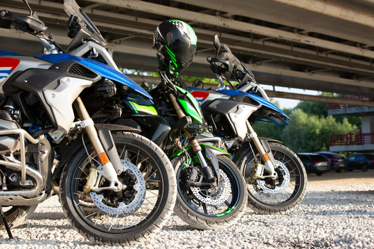 Row of three motorcycle wheels parked in a road