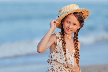 Portrait of little girl with a hat on the beach. Retro style