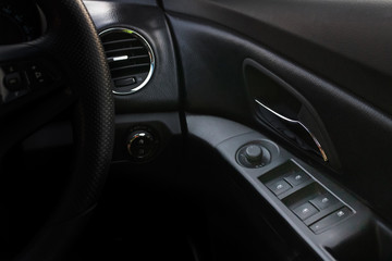 Fototapeta na wymiar Electronic car's windshield adjustment knobs and joystick of Chevrolet cruise on driver seat. Bangkok, Thailand November 20, 2017
