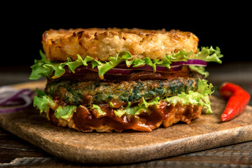 Healthy lifestyle, proper nutrition. Healthy rice burger with vegetables, herbs and cutlet