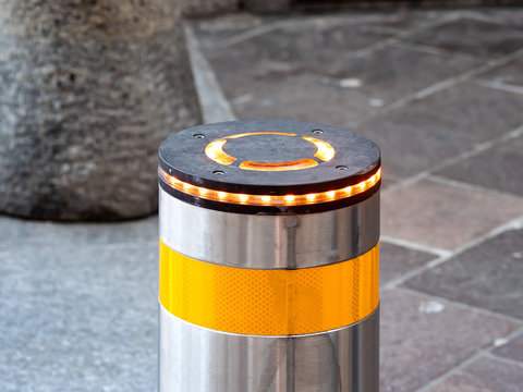 Automatic retractable bollard with glowing lights for control of road traffic and parking.Light, Architecture, Automatic, Blocking, Bollard