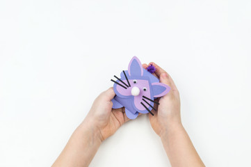 Child makes an Easter bunny out of paper. Children's hand.