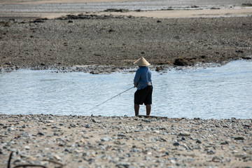  Fisherman on the bank of a river