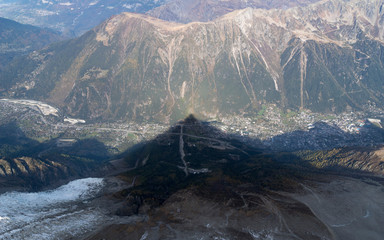 A mountain view. The shadow of Aiguille du Midi over Chamonix Mont Blanc, France