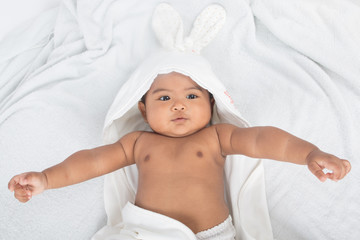 Fototapeta na wymiar Cute asian baby lying on soft blanket