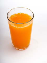 Glass of orange juice on white