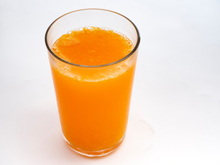 Glass of orange juice on white