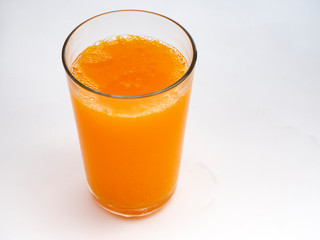 Glass of orange juice on white